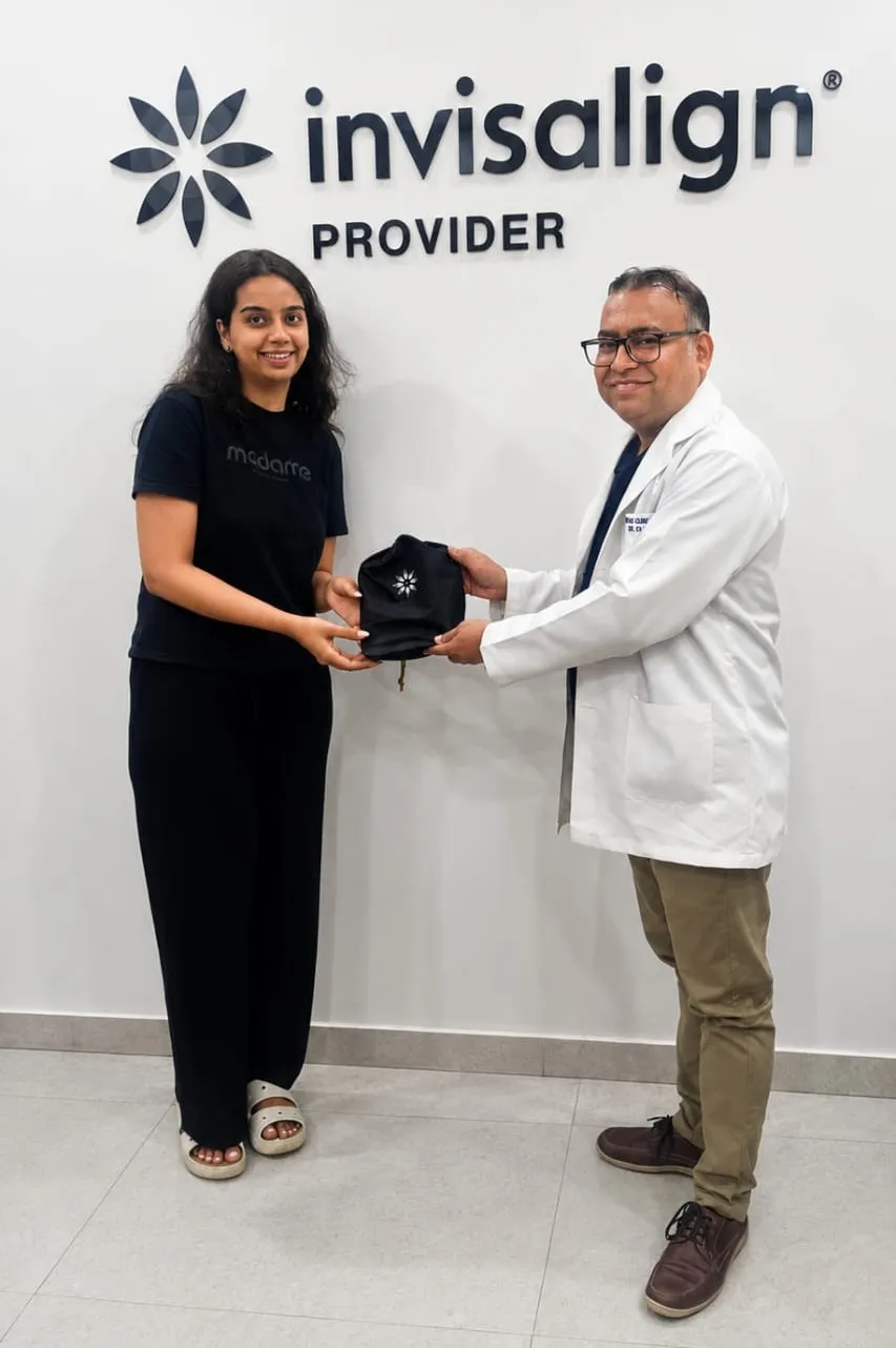 Dr. Varun Kumar Gupta with Invisalign patient at Sure Smyle Dental Clinic Gurgaon